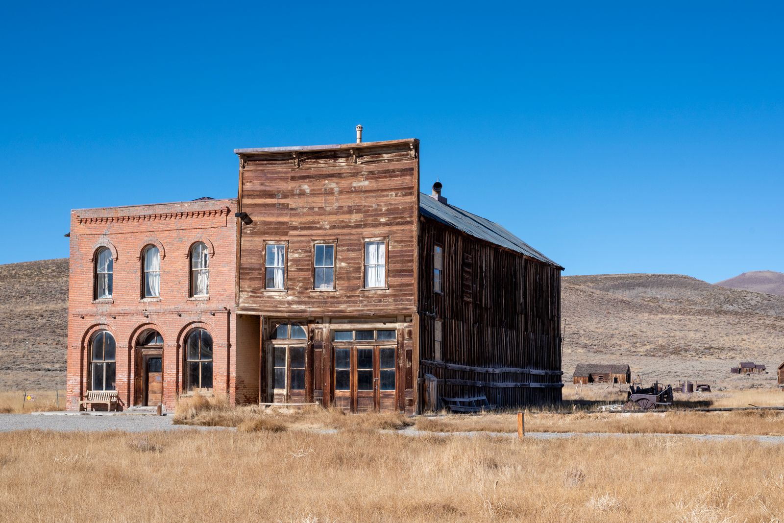 Weathered wooden and brick buildings standing in a western ghost town
